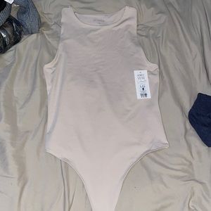 Nude scoop neck thong body suit. Size large. New with tags